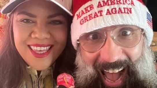 Coalition Senator Jacinta Nampijinpa Price poses in a MAGA cap with her husband Colin Lillie in this Yuletide snap taken from her social media page.
