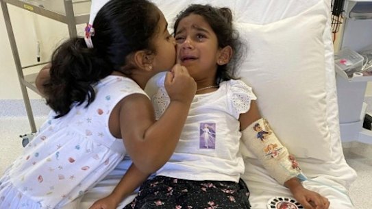 Tharnicaa and her sister Kopika in hospital on Christmas Island on June 6. 