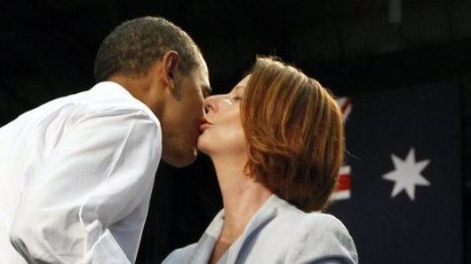 Then US resident Barack Obama and prime minister Julia Gillard kiss after addressing troops at the RAAF Base in Darwin in 2011.
