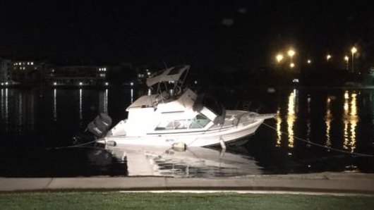 The boat has been beached on the shore of the Swan River in Fremantle near the Leftbank pub.