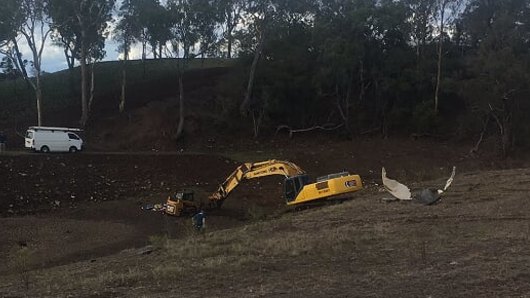 The man was crushed when the excavator's bucket dropped down and crushed him. 