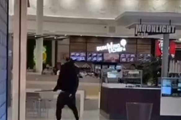 Two people with machetes fight at a Broadmeadows shopping centre on Friday night. 