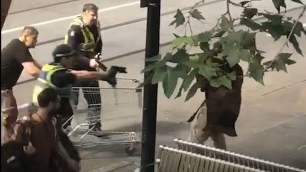 Michael Rogers tries to help police by ramming the suspect with a shopping trolley.
