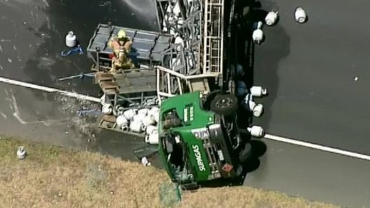 A truck carrying gas cylinders has rolled on the Eastlink near the Monash Freeway, causing delays. 