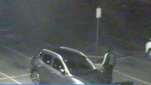 The alleged carjacker walks away after the incident in a Queanbeyan shopping centre car park.