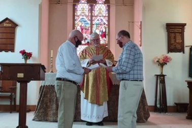 A bishop blesses the civil union of Fr John Davis and Fr Rob Whalley.
 