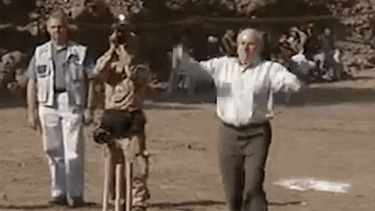 Former prime minister John Howard bowls a ball during a cricket game in Pakistan in 2005.