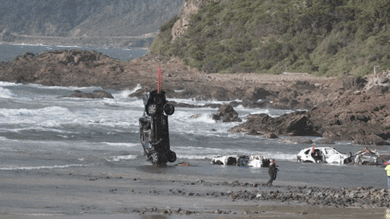 Cars winched back to land after being swept out to sea by flash floods