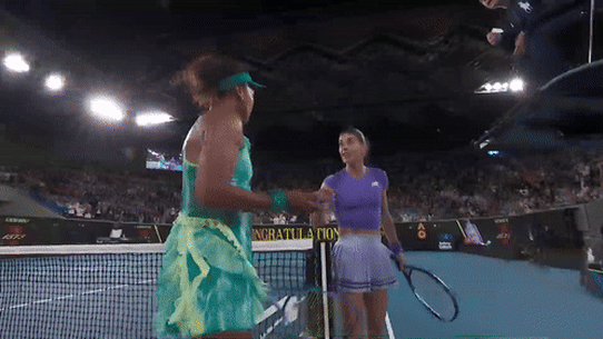 Naomi Osaka and Sorana Cirstea exchange words at the net.