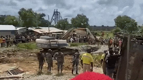 Soldiers watch on as a home is bulldozed in Talensi.