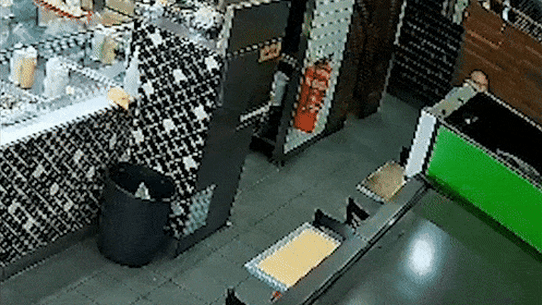 Samimjan Azari shields himself with a chair as the gunman opens fire in the Turkish restaurant.