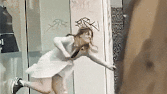 A woman was filmed smashing through the facade of a Melbourne boutique on Sunday.