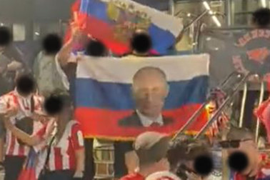 Screenshot of Russian fans carrying the national flag at Melbourne Park. Faces have been blacked out.