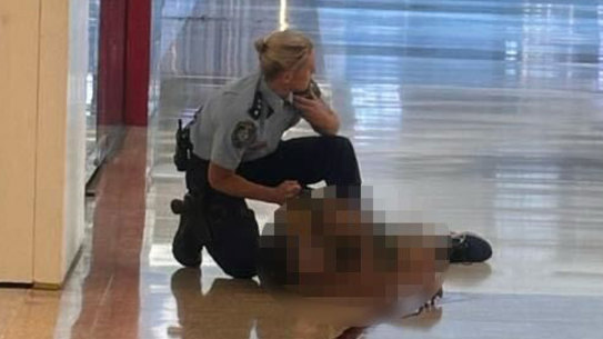 An image circulated on social media showed the police inspector attending to the attacker after shooting him.