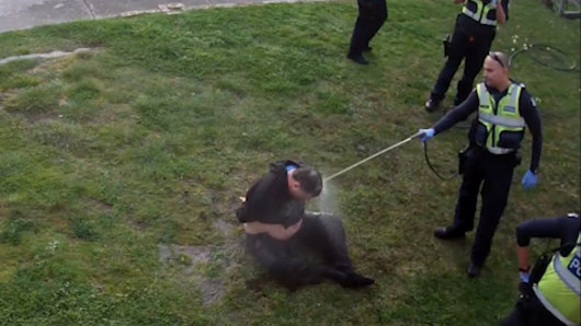 CCTV footage showed John, a disability pensioner, being hosed by police.