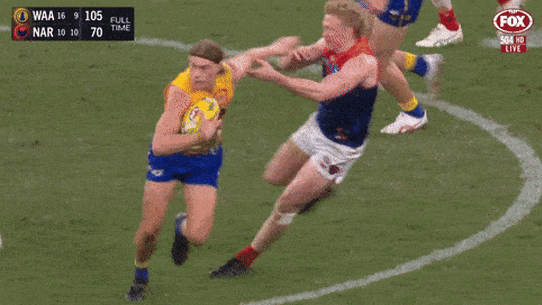 Harley Reid fends off Melbourne opponents Clayton Oliver and Christian Petracca.