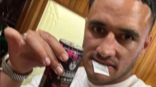 Valentine Holmes with a white bag in his mouth.