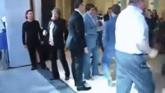 Dmitry Medvedev, next to the man in a white shirt, dancing at a university reunion. 