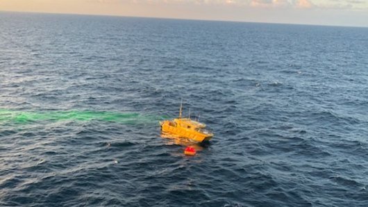 Two fishermen rescued from life raft after boat sinks off Queensland