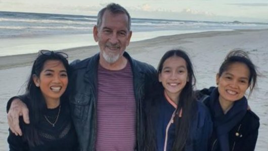 Canberra nurse Sarah Caisip (far left) was granted a few minutes alone with her father, Bernard Prendergast (centre), at the end of his funeral.