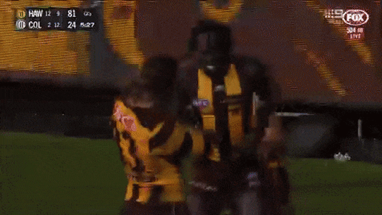 Hawthorn’s Jack Ginnivan and Changkuoth Jiath celebrate playfully after a goal against Collingwood.