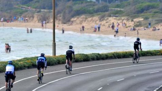 Around the Bay in a day bike ride. Cyclists approach Frankston beach.