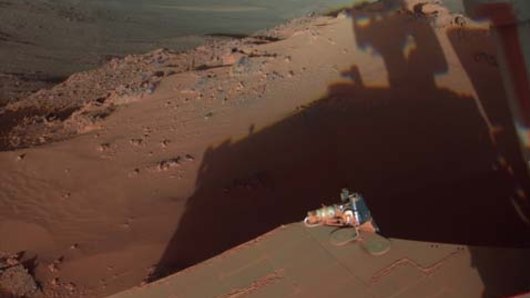 The rover Opportunity catches its own late-afternoon shadow in a view eastward across Endeavour Crater on Mars. 