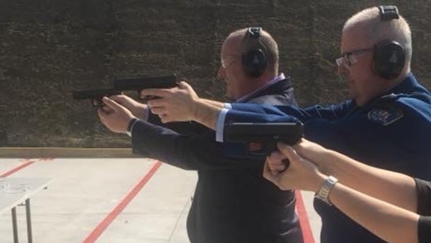 David Elliott, left, holding a prohibited weapon at the Corrective Services firing range in 2018.