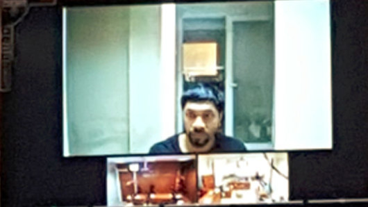 Long road: Prakash appears on a video screen during a court appearance in Turkey.