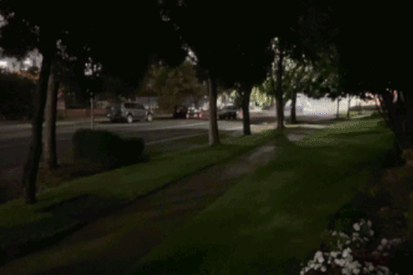 A hoon driver leaves a trail of smoke down a residential strip in Port Melbourne. 