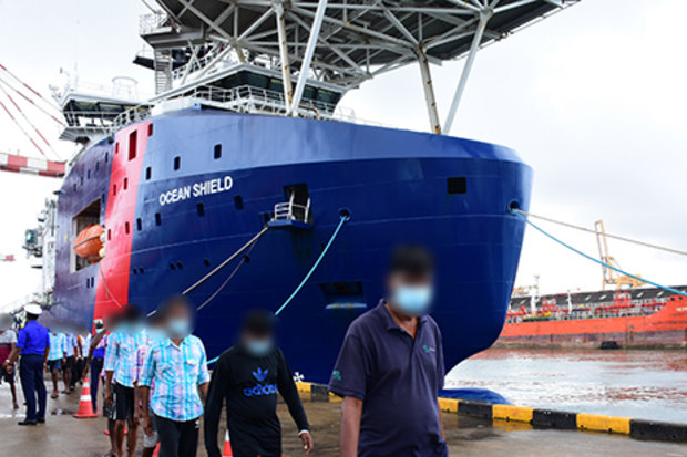 Sri Lankan men are led off the Australian Border Force ship Ocean Shield in Colombo in August.