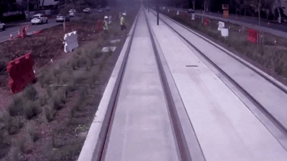 A construction worker narrowly avoids being hit by light rail.