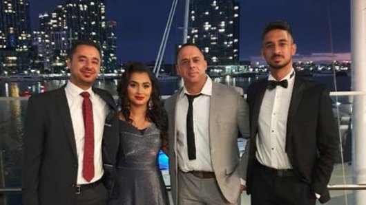 Aaron Osmani wearing a grey suit with his siblings (L-R) Hamid, Lina and Jawid.