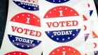 A poll worker holds “I Voted” stickers during the first day of early voting at a polling station in Wilmington, North Carolina. 