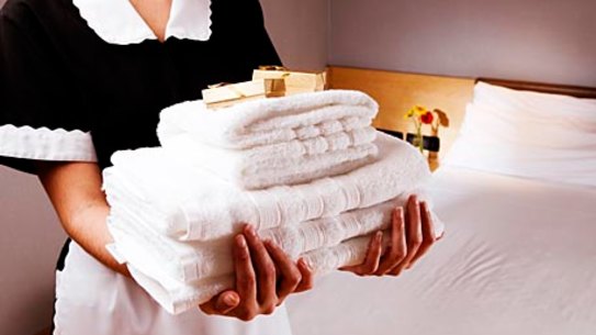 Hotel maid with towels.