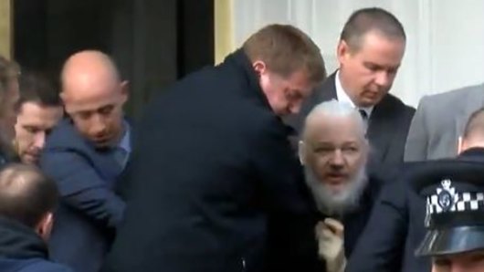 Julian Assange is bundled out of the Ecuadorian embassy by London police.