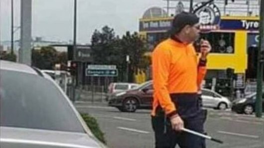 A Melbourne resident has uploaded this picture to social media, claiming the man was a police officer pretending to be a window washer.