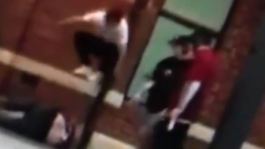 The footage shows one man jumping in the air and landing on the head of the victim.
