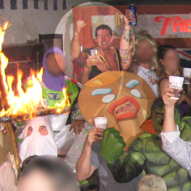 Ben Roberts-Smith, highlighted, back left, smiles and pumps his fist as a soldier in a Ku Klux Klan outfit burns a cross.