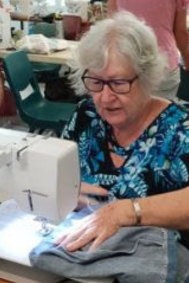 Reef Sister Pat sewing pyjamas.
