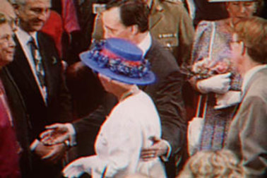 Paul Keating guides the Queen with a hand on her back.