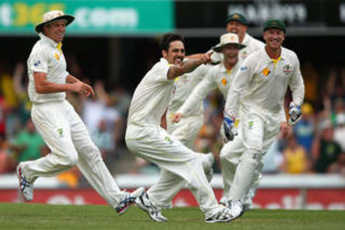 Mitchell Johnson celebrates taking the wicket of Graeme Swann of England during the First Ashes Test match at The Gabba in 2013.
