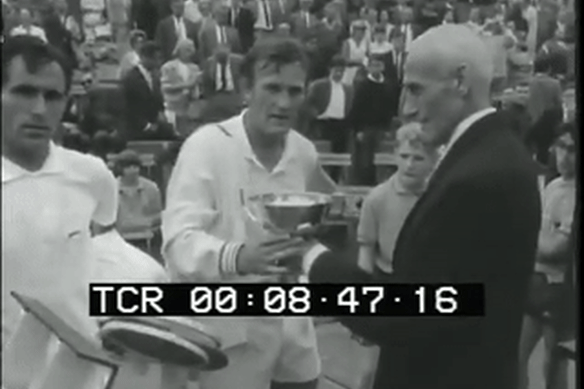 Tony Roche receives the trophy after winning the 1966 French Open at Roland Garros.