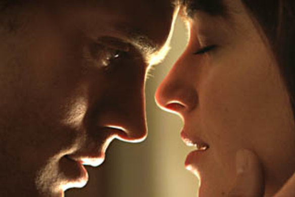 Jamie Dornan and Dakota Johnson appear in a scene from ‘Fifty Shades of Grey’.