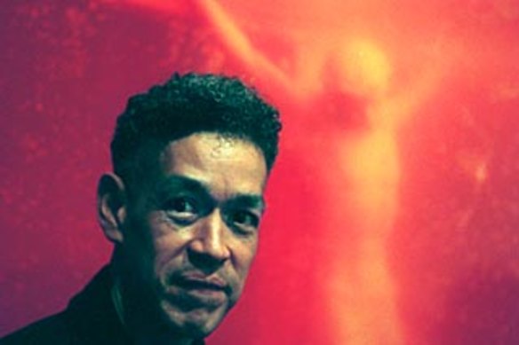 Andres Serrano in front of his controversial work, Piss Christ, that was considered by some to be blasphemous. 
