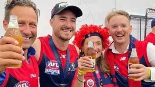 Hayden Burbank (left) and Mark Babbage (right) inside the AFL rooms after Melbourne’s win at the Grand final.