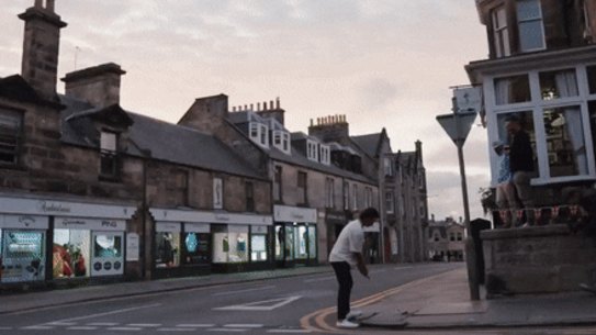 Harrison Crowe hits the green at the St Andrews 18th from a pub.