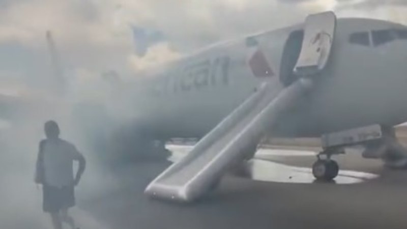 Passengers flee smoking plane on emergency slide at Denver airport