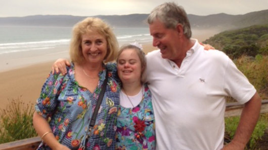 Anna Fisken, centre, with her parents Susie and Geoff. Anna has Down syndrome and has become more independent since taking part in the National Disability Insurance Scheme.