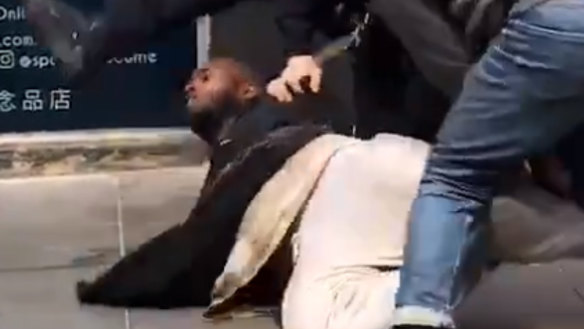 The man being arrested by police after being shot.